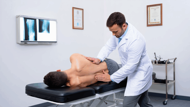Chiropractor adjusting a patient’s spine in a clinic